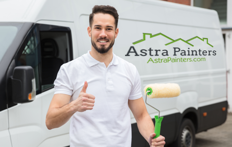 An Astra Painters painter beside the company van
